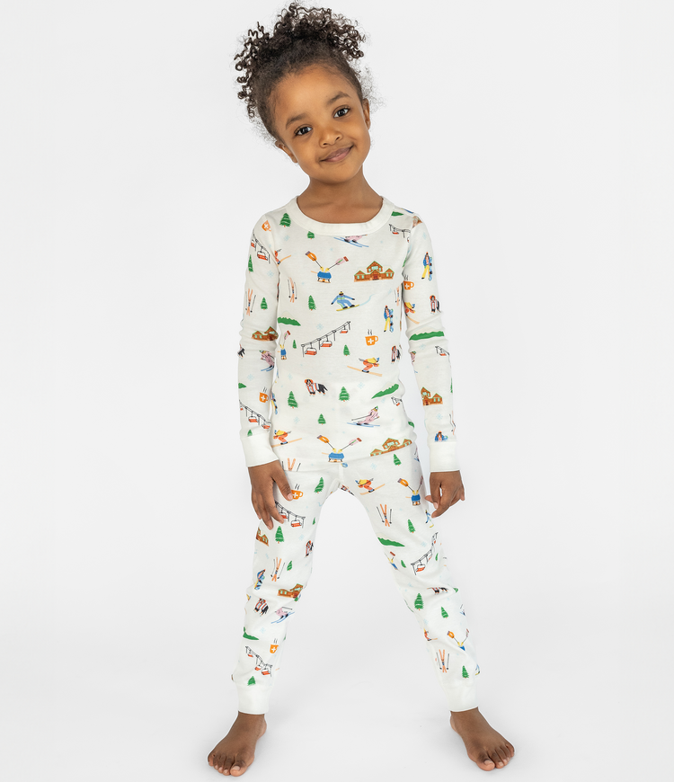 Child Posing in Smaller Things Pajama Set - Ski Resort Print on 100% Organic Cotton Long Sleeve Top and Bottom