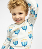 Child posing in a comfy Goodnight Hannukah print on Kids Unisex Pajamas Set made of 100% organic cotton