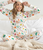 100% Organic Cotton Pajama Set with Artist-Illustrated Vintage Ornaments - Woman Enjoying Comfortable Sleepwear in Bed