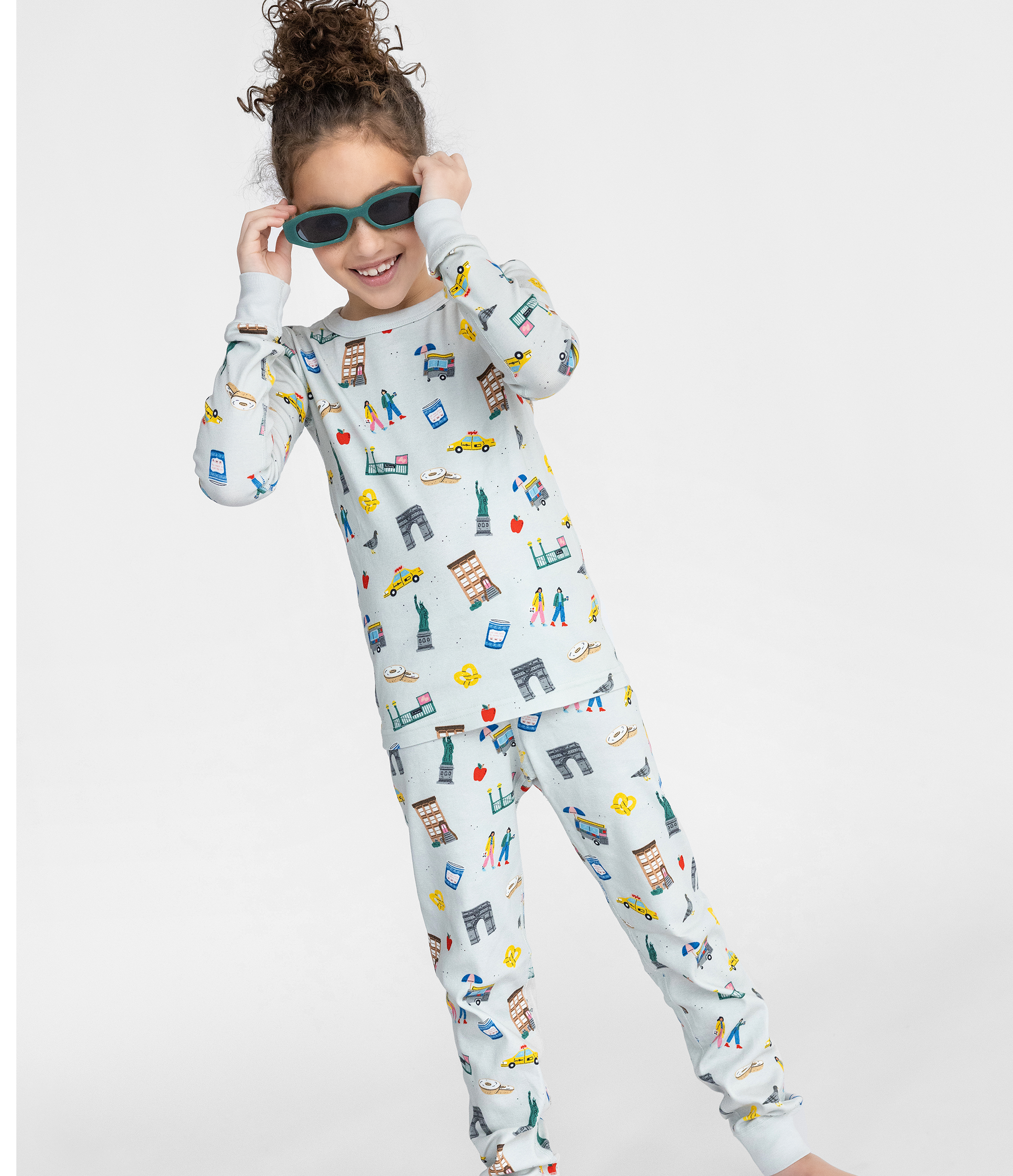 Child Posing in Smaller Things Long Sleeved Pajama Set - NYC-themed print on 100% organic cotton top and bottom