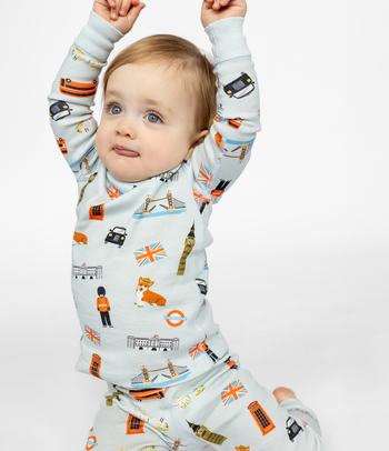 12-month old girl in her fun London themed pajama set. 100% organic cotton. Long sleeve top and pants. Long John two piece set for kids. Comfortable and cozy sleepwear.  