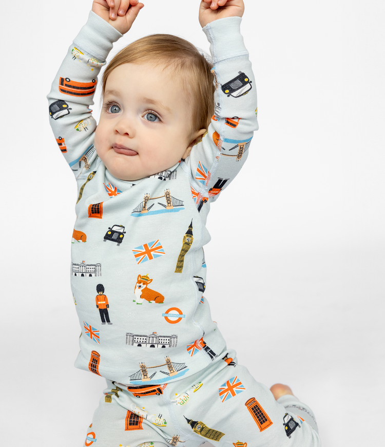 Image of a 12-month old girl enjoying her London themed pajamas.  This British themed pajamas set features all the London favorite things.